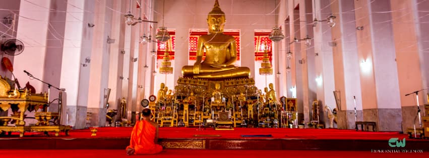A Buddhist practicing meditation in front of the principal Buddha image at Wat Mahathat