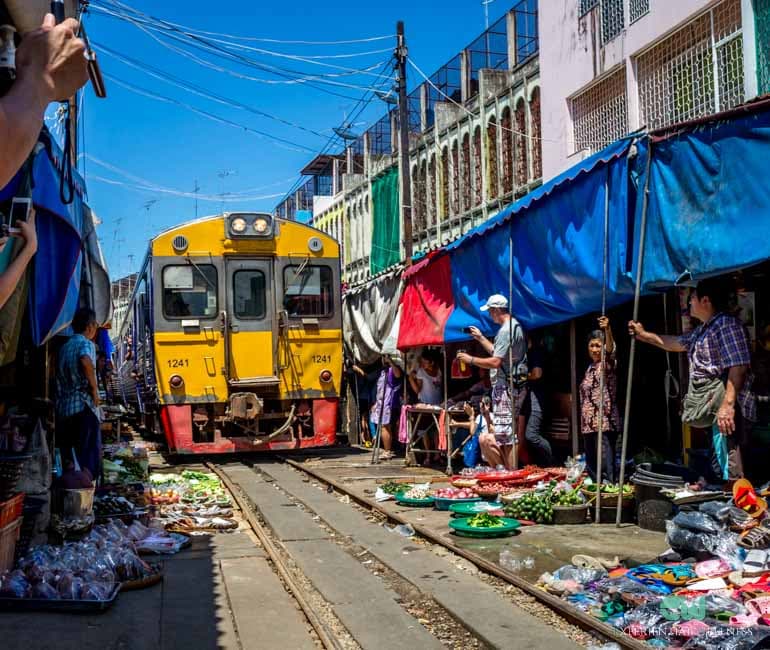 Train passing through a local market