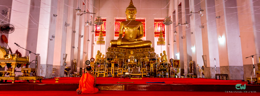 A Buddhist is practicing meditation in front of the principal Buddha image at Wat Mahathat