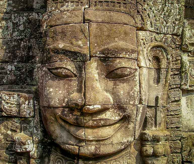 The smiling face of King Jayavarman VII inside a temple in Angkor Thom