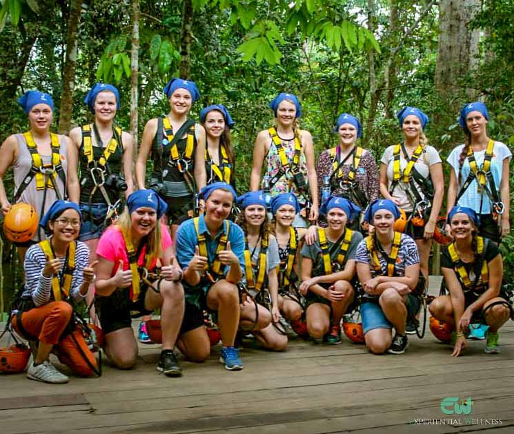 A girl group is taking a photo together before they begin their zipline canopy adventure