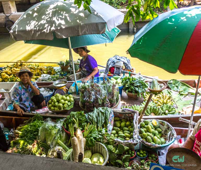 Tourists are bargaining with a local merchant at Lad Mayom Floating Market