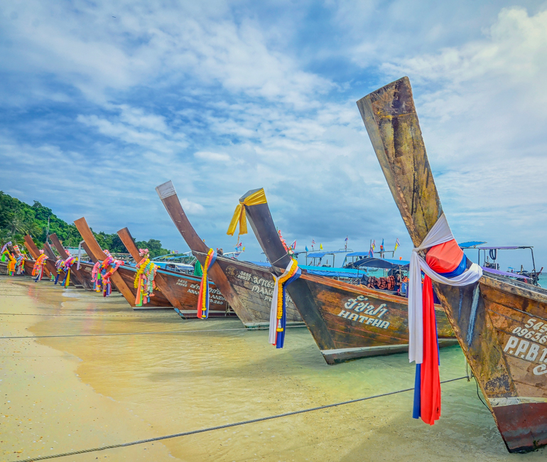 Tens of long-tail boats stop near the famous beach in Phuket
