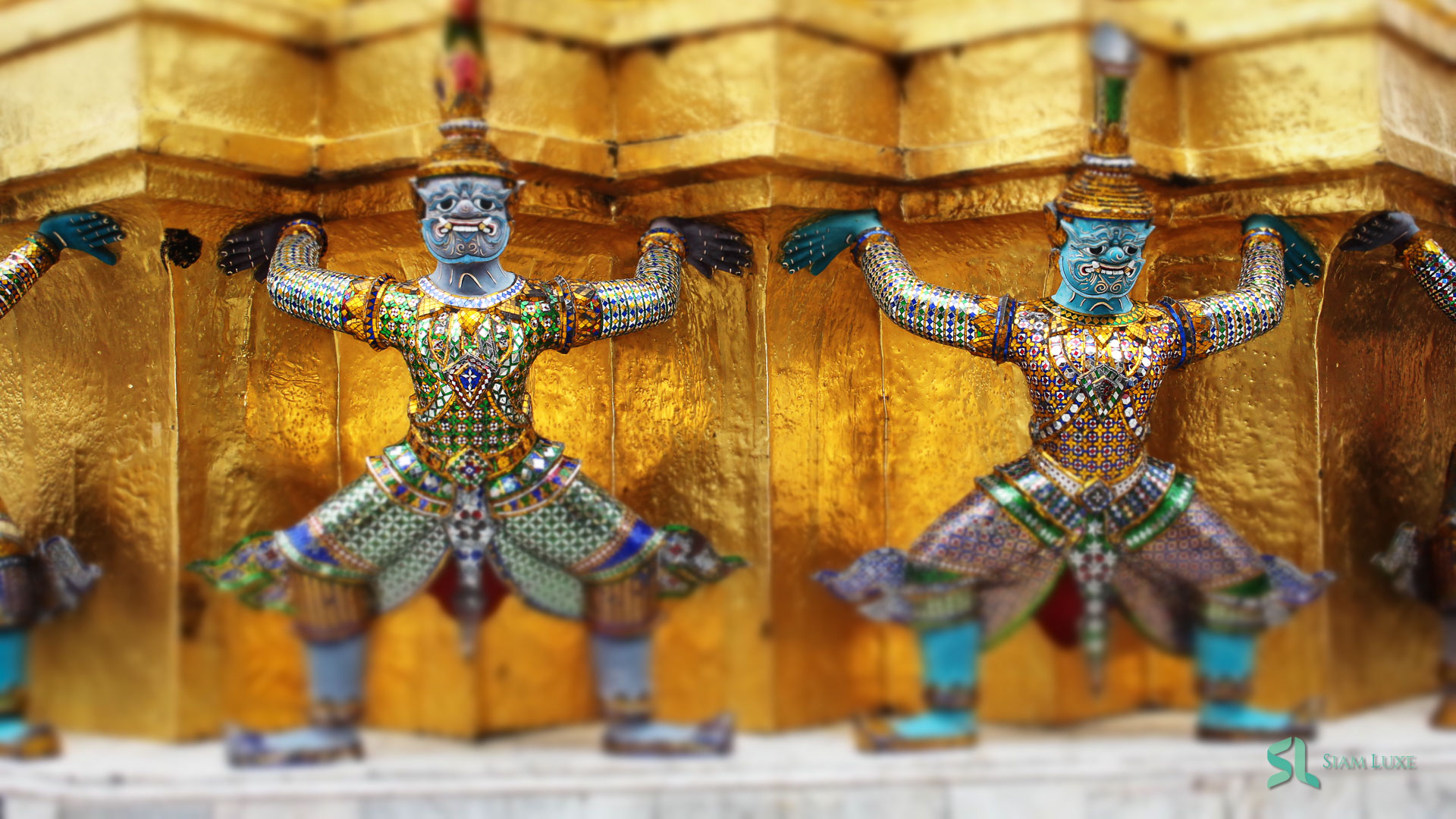 The demon guardian support the gilded stupas in Wat Phra Kaew, Bangkok, Thailand